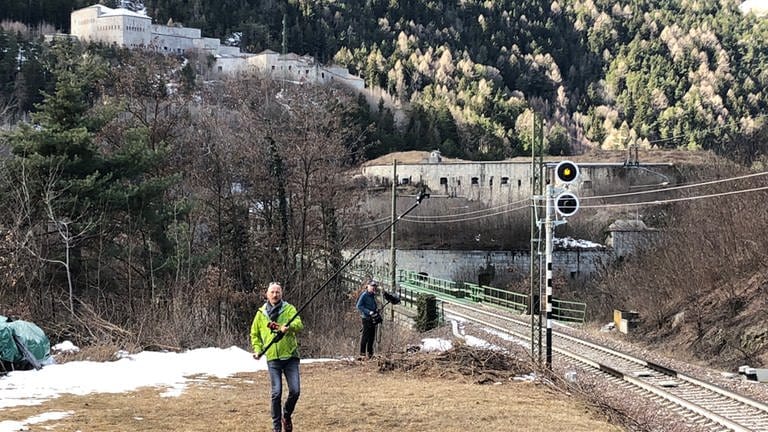 Mit einer Gopro (=Action-Kamera) am Stab wollen wir die Pustertalbahn ein weiteres Mal vor ihrer Einfahrt in die Franzensfeste abfangen. (Foto: SWR, Kirsten Ruppel)