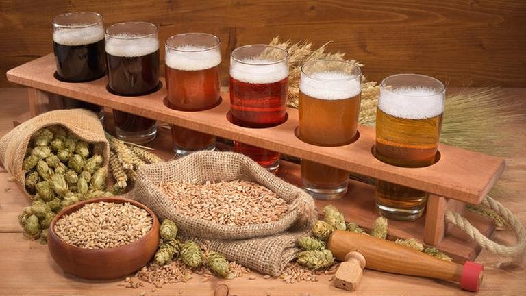 Verschiedene Biersorten steehen in Gläsern in einer Holzhalterung. (Foto: Getty Images, Thinkstock -)