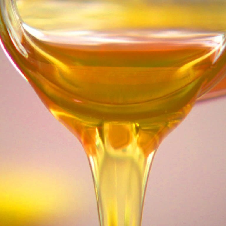 Honig fließt goldgelb, zäh aus einem Glas (Foto: SWR)