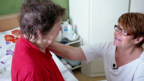 Pflegerin wendet sich Patientin zu (Foto: SWR)