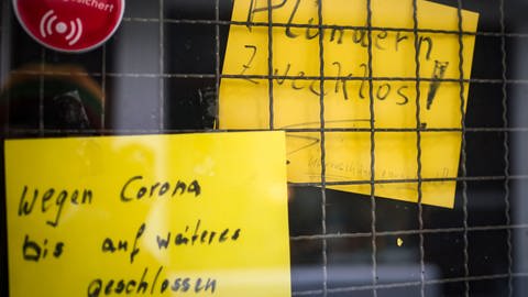 «Wegen Corona bis auf weiteres geschlossen» und «Plündern zwecklos» verkünden Schilder an der Tür zu einem wegen der Corona-Epidemie geschlossenen Geschäfts in der Altstadt (Foto: dpa Bildfunk, picture alliance/dpa | Frank Rumpenhorst)
