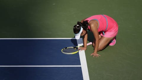 Die chinesische Tennisspielerin Shuai Peng kauert 2014 nach einem Hitzschlag am Rand des Tenniscourts in Flushing Meadows, New York (Foto: dpa Bildfunk, Picture Alliance)