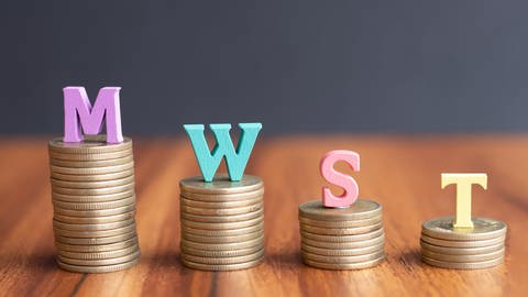 MwSt. auf Münzen in absteigender Reihenfolge - Konzept zur Darstellung der sinkenden Steuersätze (Foto: Adobe Stock, Adobe Stock/WESTOCK)