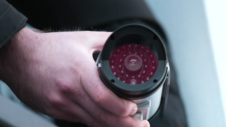Eine Kamera-Attrappe ist eine kostengünstige und einfache Alternative zur Installation einer echten Überwachungskamera. Ein Mann installiert draußen eine Kamera-Attrappe. (Foto: SWR)