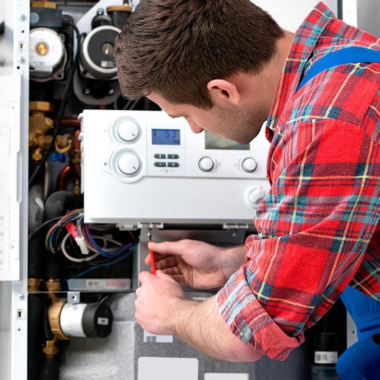 Ein Mann baut eine Heizung ein (Foto: Getty Images, Thinkstock -)